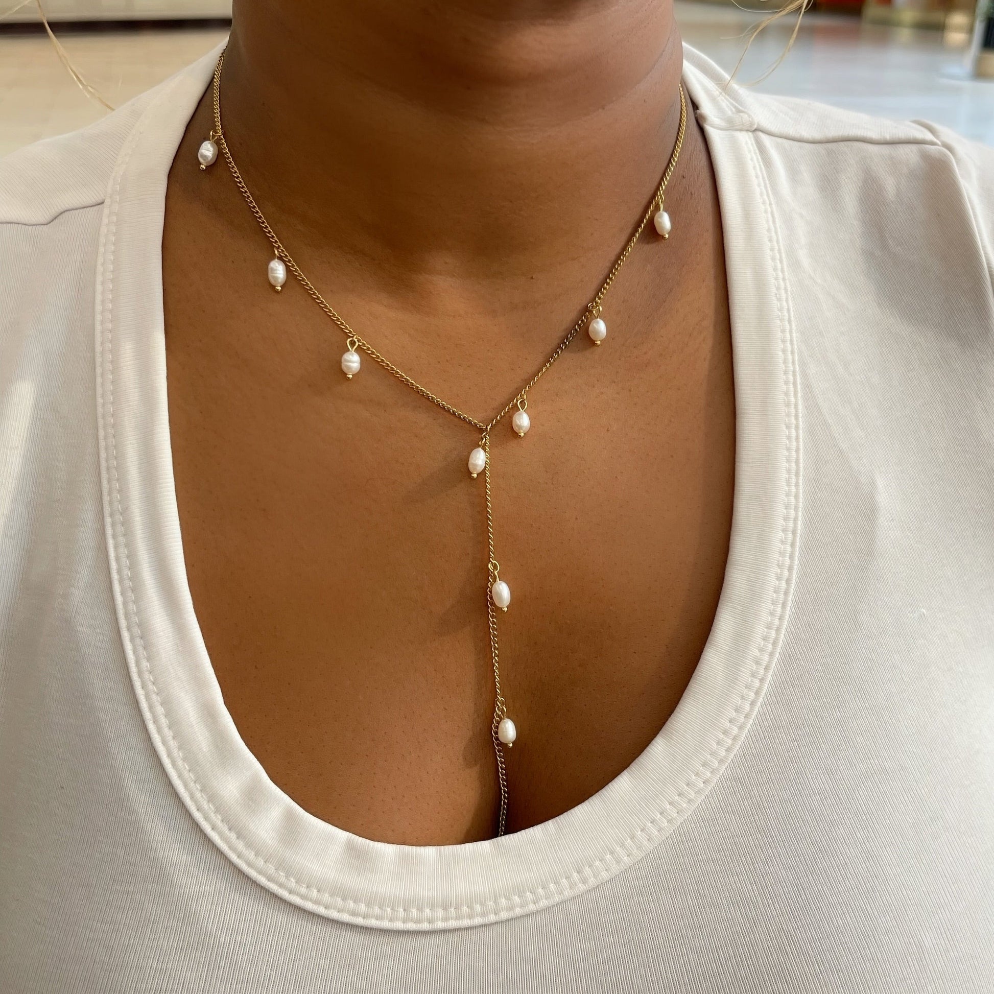 Pearl necklace worn by a person in a casual setting
