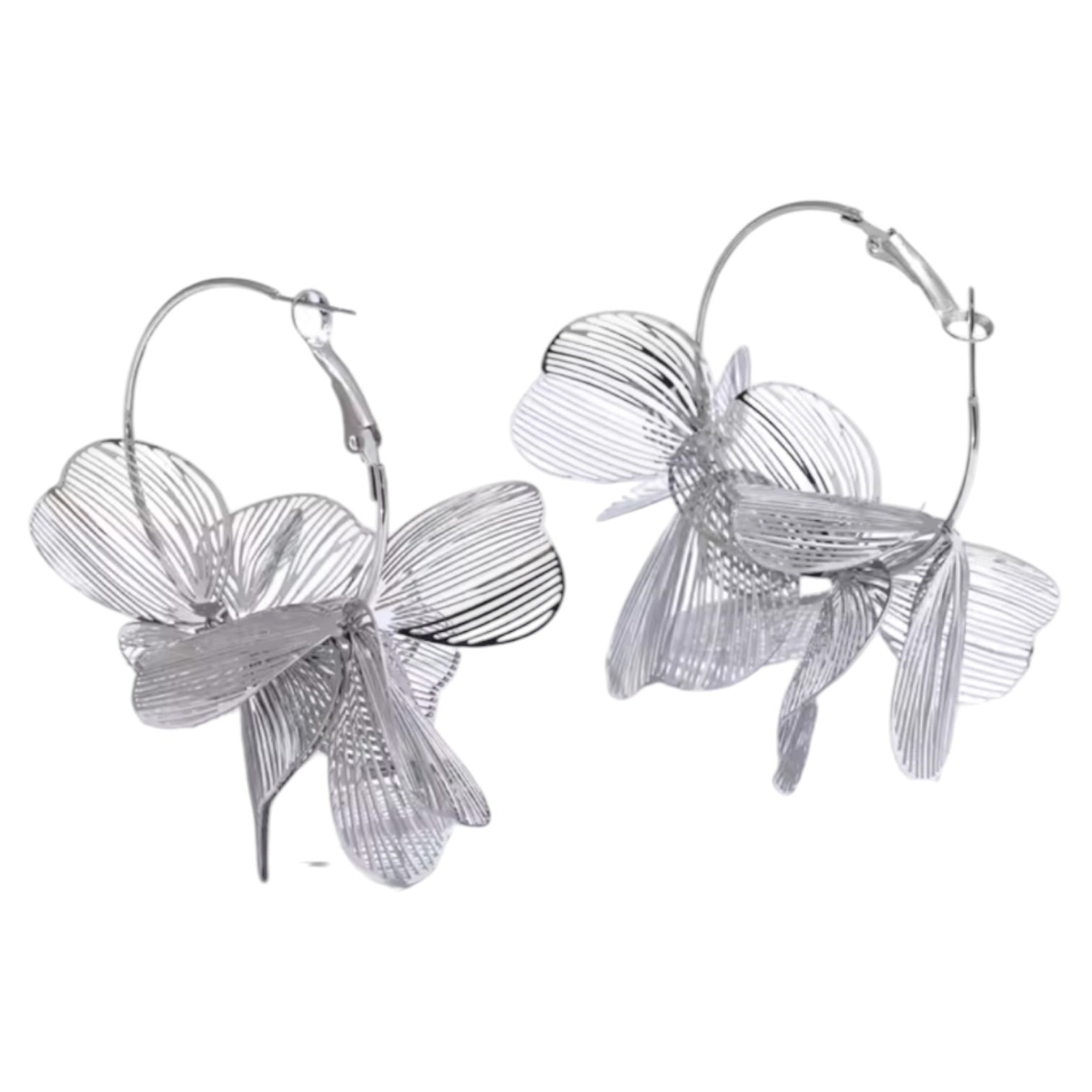 Silver floral hoop earrings on a white background