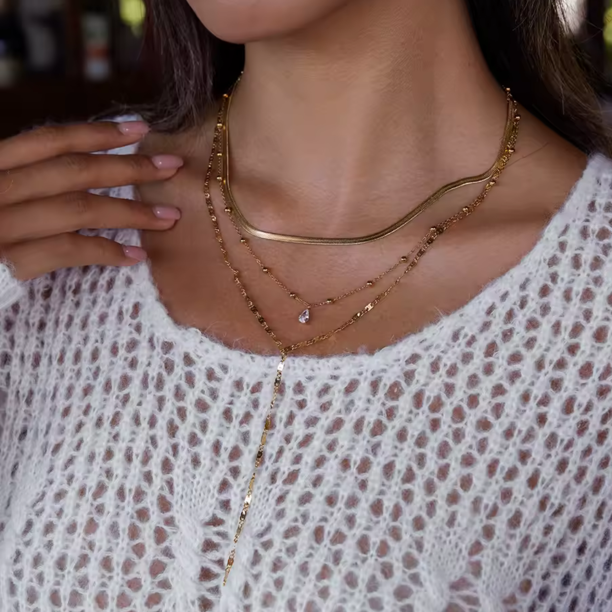 Necklace worn by a person with a blurred background