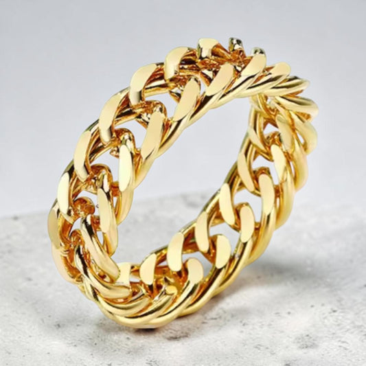 Gold chain-style ring on a light gray background